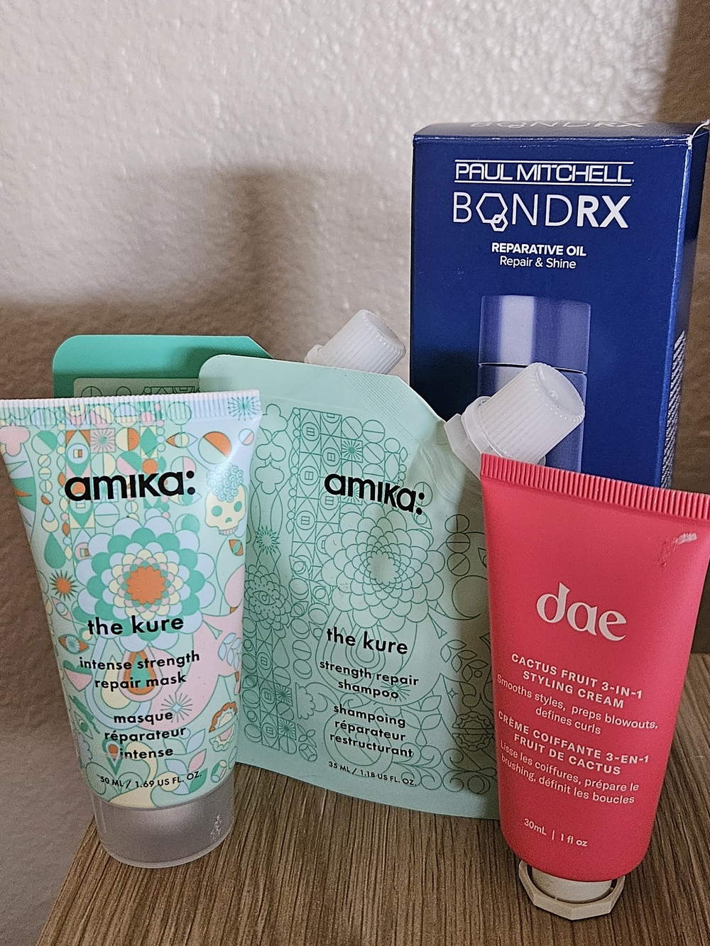 amika The Kure Travel Set, dae Cactus Fruit Styling Cream, Paul Mitchell Bond Rx